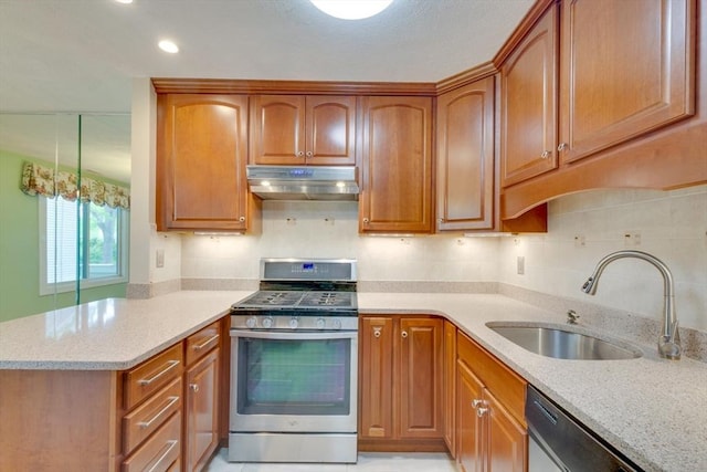 3 Concord Greene Unit 4, Concord, MA 01742 - kitchen with stainless steel appliances, under cabinet range hood, a sink, light stone countertops, and brown cabinets