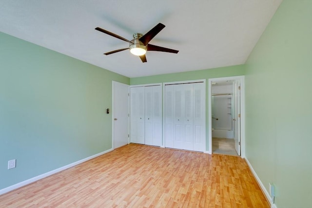 3 Concord Greene Unit 4, Concord, MA 01742 - unfurnished bedroom with light wood-style floors, multiple closets, baseboards, a ceiling fan, and ensuite bath