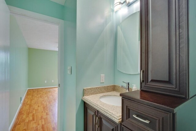 3 Concord Greene Unit 4, Concord, MA 01742 - bathroom with vanity, wood finished floors, and baseboards