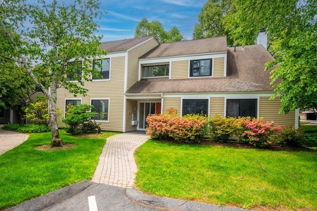 3 Concord Greene Unit 4, Concord, MA 01742 - view of front of home with a front lawn, a chimney, and roof with shingles