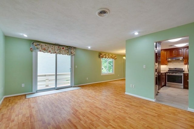 3 Concord Greene Unit 4, Concord, MA 01742 - unfurnished living room featuring light wood finished floors, baseboards, and recessed lighting