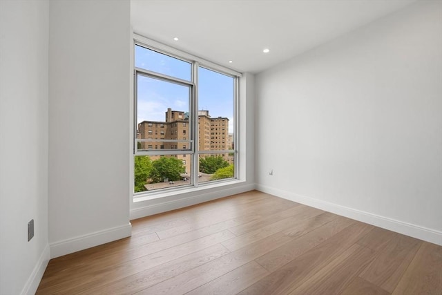 700 Harrison Ave Unit Ph-610, Boston, MA 02118 - spare room featuring baseboards, wood finished floors, recessed lighting, and a city view