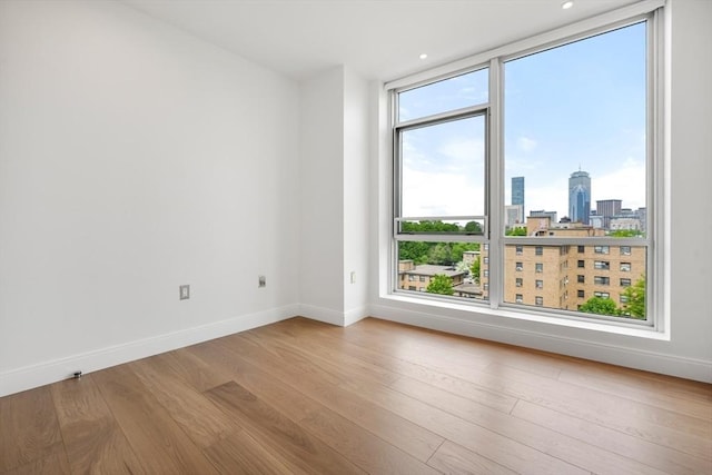 700 Harrison Ave Unit Ph-610, Boston, MA 02118 - spare room with wood finished floors, baseboards, a view of skyline, and recessed lighting