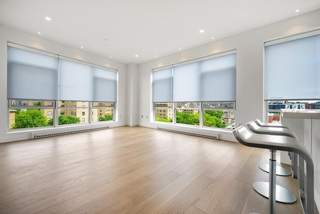 700 Harrison Ave Unit Ph-610, Boston, MA 02118 - unfurnished living room with baseboard heating, wood finished floors, and recessed lighting