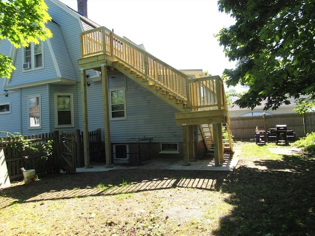 31 Graham St, Quincy, MA 02169 - back of house with stairs, a fenced backyard, a patio, and a chimney