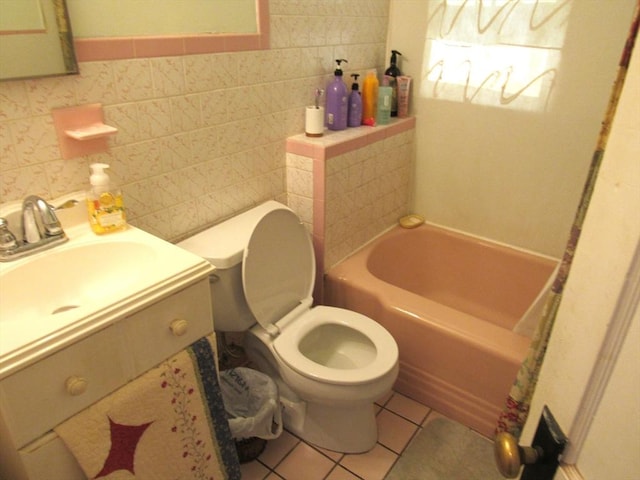31 Graham St, Quincy, MA 02169 - full bath featuring a bath, toilet, tile patterned flooring, tile walls, and vanity