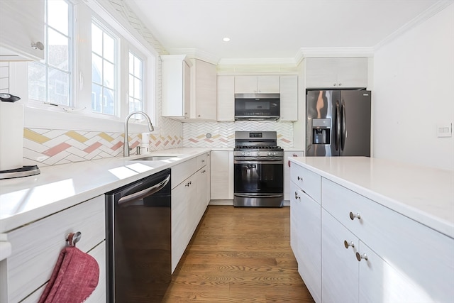 kitchen featuring dark wood-type flooring, white cabinetry, stainless steel appliances, and sink