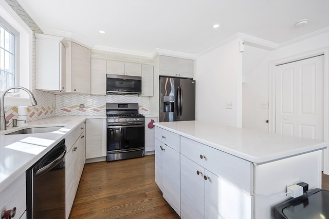 kitchen featuring appliances with stainless steel finishes, sink, ornamental molding, decorative backsplash, and dark hardwood / wood-style floors