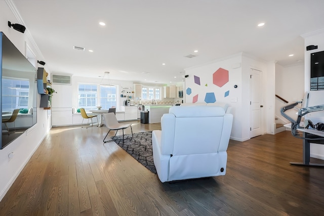 living room featuring crown molding and hardwood / wood-style flooring