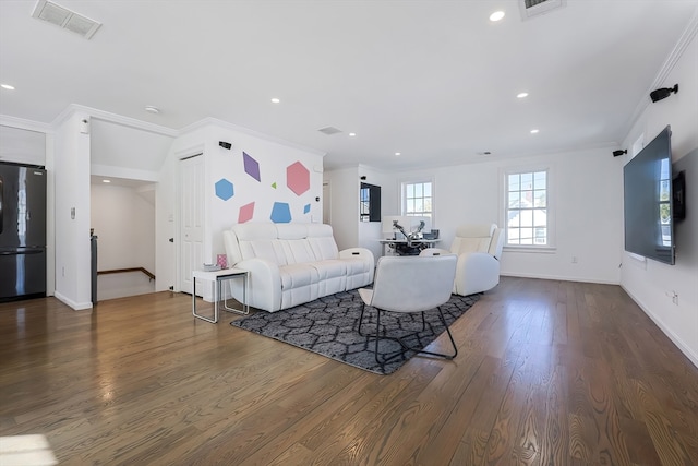 living room with ornamental molding and dark wood-type flooring