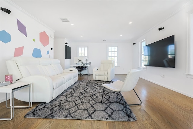 living room featuring ornamental molding and wood-type flooring