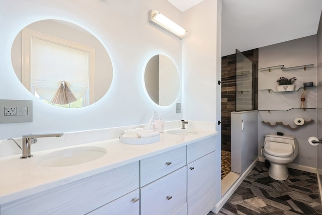 bathroom with vanity, toilet, and a tile shower