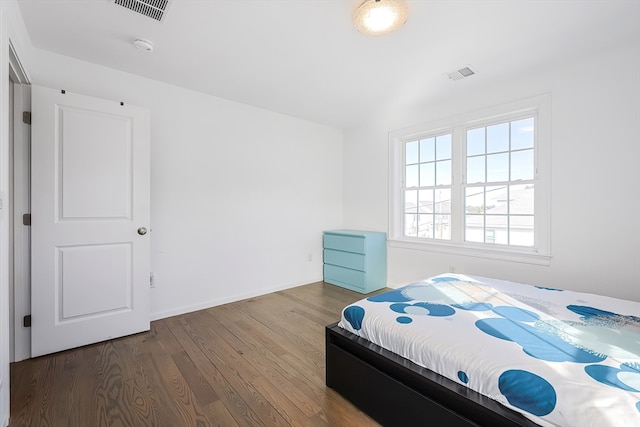 bedroom with hardwood / wood-style flooring