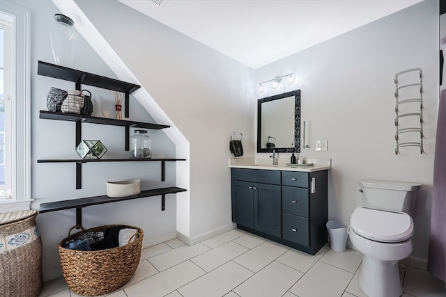 bathroom featuring toilet, vanity, and tile patterned flooring