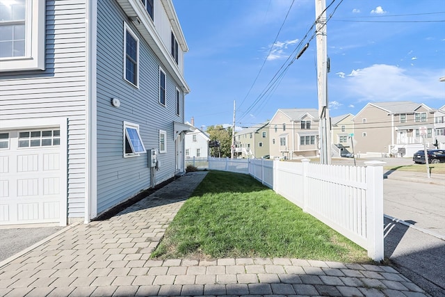 view of home's exterior featuring a yard and a garage