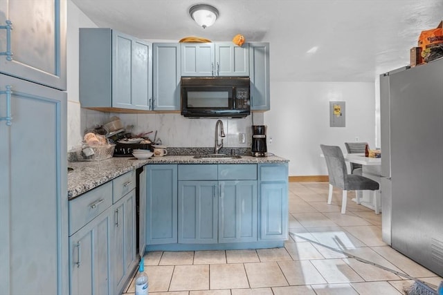 56 N Warren Ave, Brockton, MA 02301 - kitchen featuring black microwave, freestanding refrigerator, dark stone countertops, backsplash, and light tile patterned floors