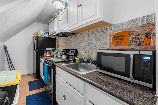 56 N Warren Ave, Brockton, MA 02301 - kitchen featuring appliances with stainless steel finishes, vaulted ceiling, white cabinetry, light wood-style floors, and decorative backsplash