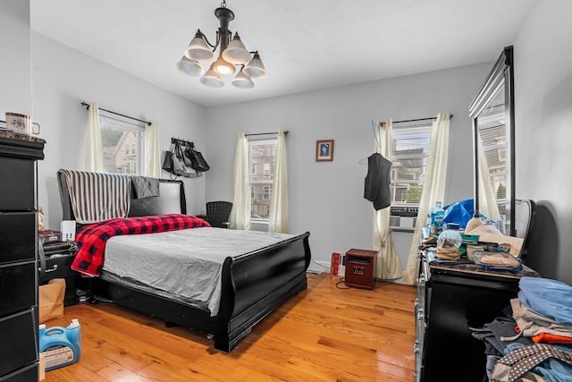 56 N Warren Ave, Brockton, MA 02301 - bedroom with a chandelier and light wood-style floors
