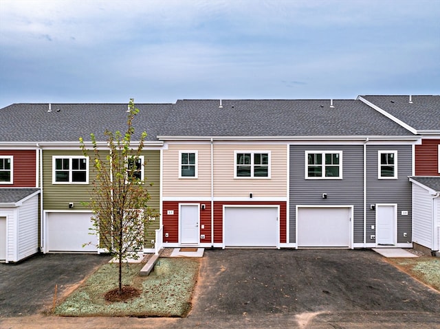 townhome / multi-family property featuring a garage