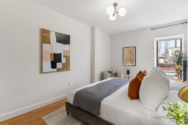 bedroom with wood finished floors and baseboards