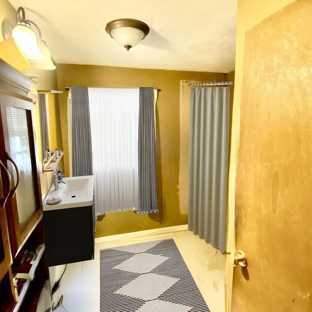 bathroom featuring walk in shower and vanity