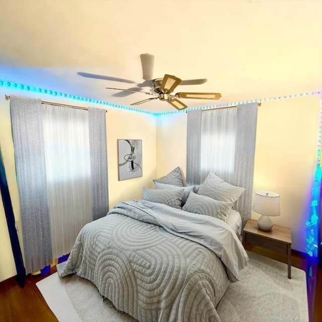 bedroom with wood-type flooring and ceiling fan