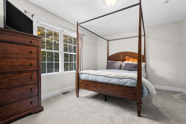 bedroom featuring light carpet