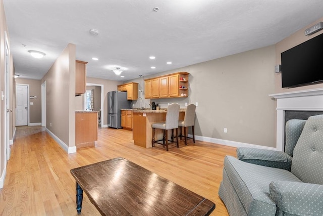 living room with sink and light hardwood / wood-style flooring