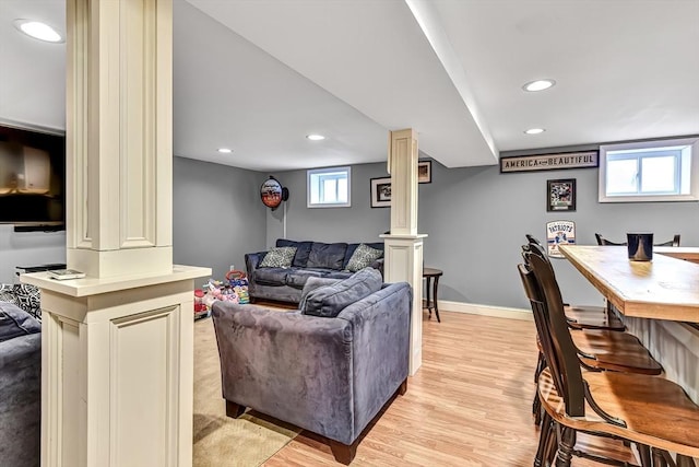 living room featuring light wood-type flooring, ornate columns, baseboards, and recessed lighting