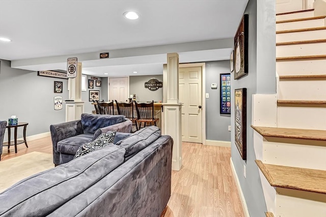 living room featuring light wood-style flooring, baseboards, and recessed lighting