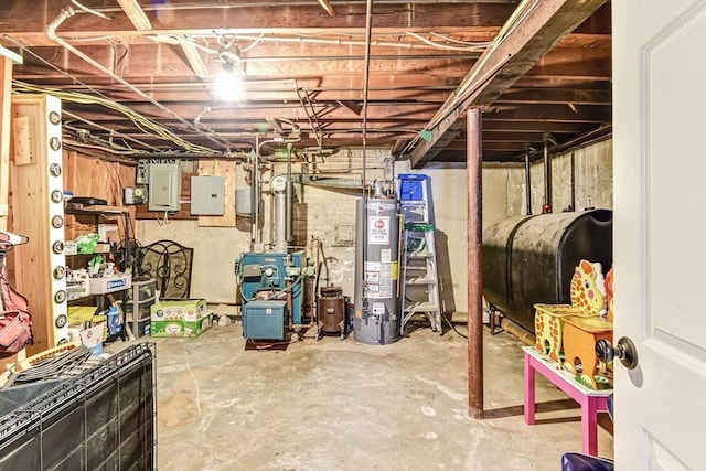 unfinished below grade area featuring gas water heater, a heating unit, electric panel, and heating fuel