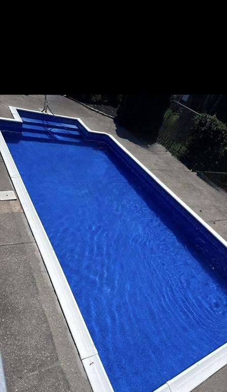 view of swimming pool with fence and a fenced in pool