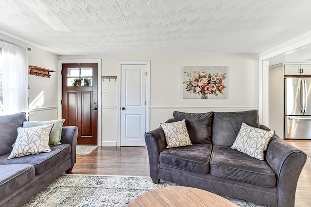 living room featuring a textured ceiling and wood finished floors