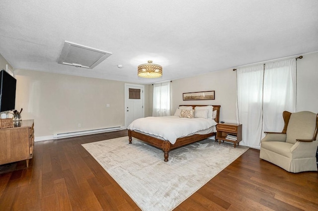 7 Washington St, Groveland, MA 01834 - bedroom with a baseboard heating unit, attic access, and dark wood-type flooring
