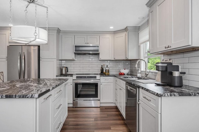 7 Washington St, Groveland, MA 01834 - kitchen with appliances with stainless steel finishes, backsplash, dark wood-type flooring, dark stone counters, and recessed lighting
