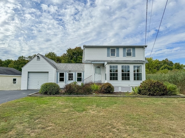 view of front facade with a garage and a front lawn