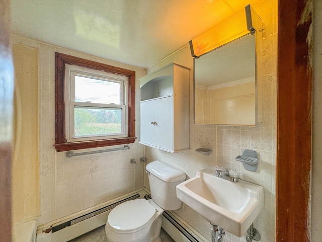 bathroom with tile walls, baseboard heating, and toilet