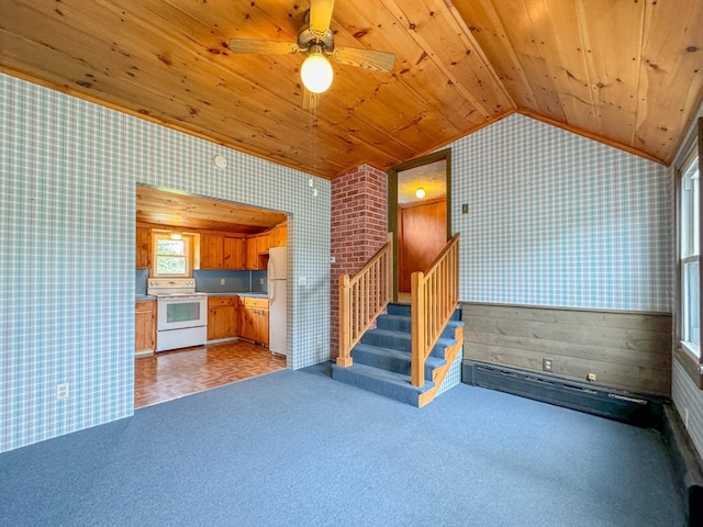 unfurnished living room featuring wood ceiling, vaulted ceiling, and carpet