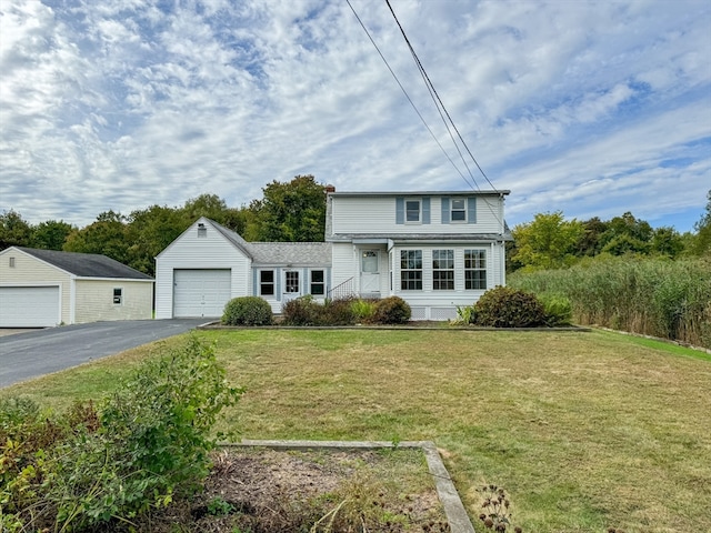 view of front of home with a front lawn and a garage