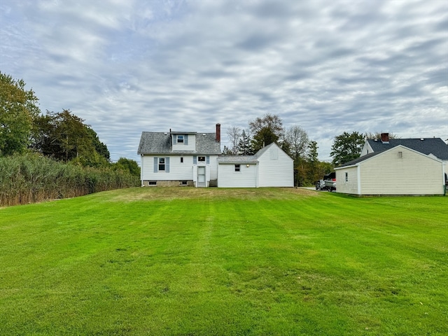 back of house with a lawn