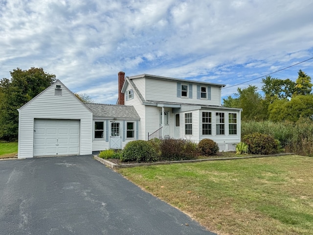 view of property featuring a front yard and a garage