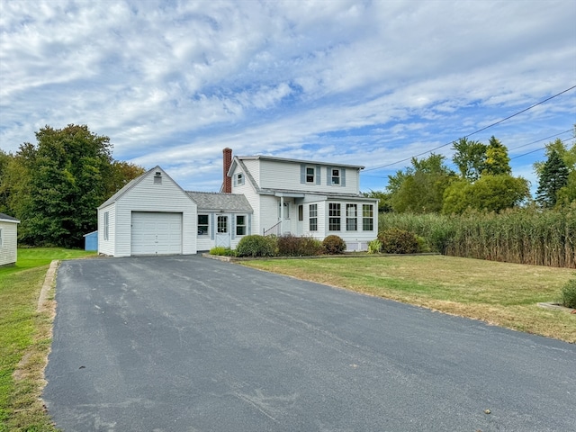 front of property with a garage and a front lawn