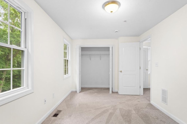 14 Watson St Unit 14, Lowell, MA 01852 - unfurnished bedroom featuring carpet floors, multiple windows, and a closet