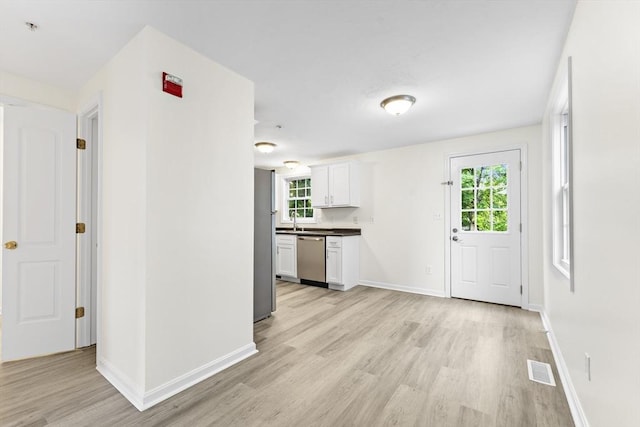 14 Watson St Unit 14, Lowell, MA 01852 - kitchen with dishwasher, light wood-style flooring, white cabinetry, and dark countertops