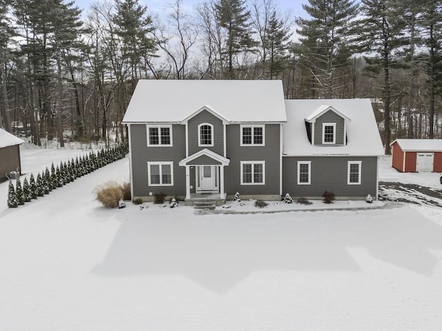 view of front of house with a storage shed