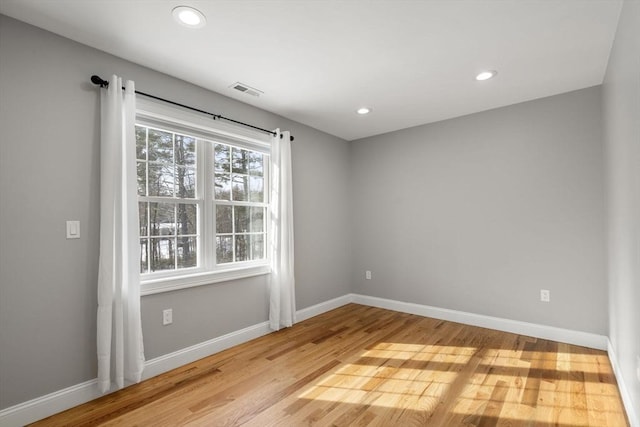 spare room featuring light hardwood / wood-style floors