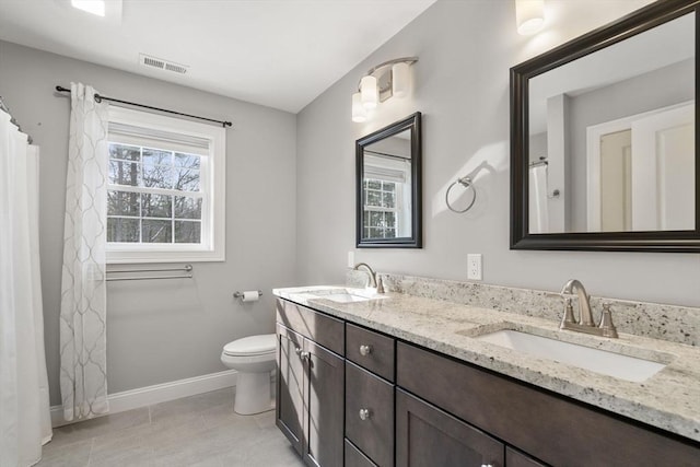 bathroom featuring vanity, tile patterned flooring, and toilet