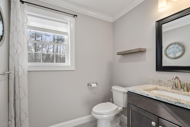 bathroom with crown molding, vanity, and toilet