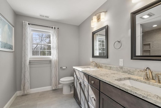 bathroom with vanity, toilet, and tile patterned flooring