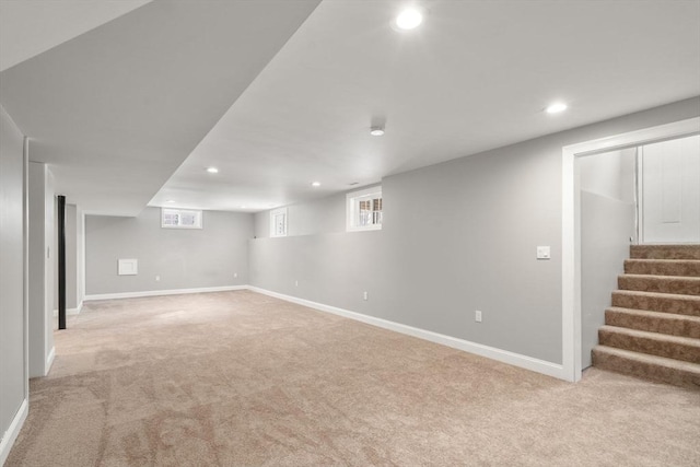 basement featuring light carpet